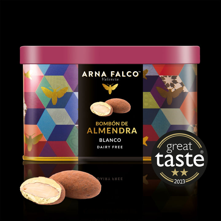 A colourful tin box of Dairy-Free, white chocolate coated almonds by Arna Falco Valencia, featuring a "Great Taste 2023" award label and decorated with a geometric and butterfly pattern.